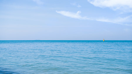 Sea Summer with Blue Sky Background,Blue Ocean with Cloud White Beautiful Seascap,Smooth Wave of Water Calm Nature,Shore Tropical at Coast,for Tourism Relax Vacation in Holidays,Landscape Wallpaper.の写真素材