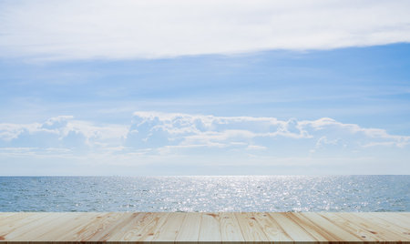 Summer Table on Sea Background,Bar Counter Wooden on Ocean with Cloud Blue Sky on Sun Day,Empty Desk Mockup on water Nature Outdoor,for Travel Tropical Holiday,Counter Bar Free Space for Presentation.の写真素材