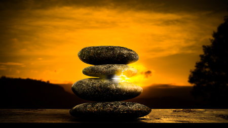 Double Exposure Stack Stone on Sunset Background,Design Buddhism Nature Therapy Spa Massage,Concept for Aroma therapy Calm Meditation Religion,Rock with Sunrise.の写真素材
