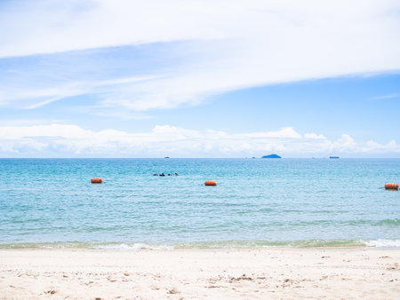 Blue Sea on Beach with Cloud Sky Background,Splash Wave Water on Sand at Coast,Nature Landscape Summer for Travel,Ocean Island Tropical for Tourism Vacation in Holidays.の写真素材