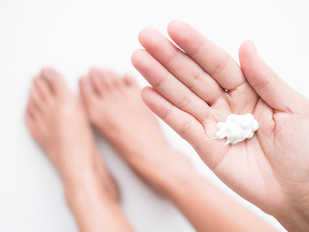Body Lotion on Finger Woman,Girl Apply Moisturer Cream Gel on Leg and Foot at Home,Natural Spa Medicine Treatment Herb Serum,Cosmetic for Beauty and Health Concept.の写真素材