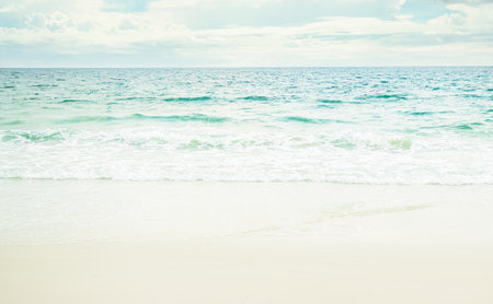 Beach Sand with Sea Shore Water Summer and Blue Sky Background,Cloud White with Wave Ocean Island at Coast,Beautiful Seascape Nature Space,for Tourism Vacation Travel Summer Holidays.の写真素材