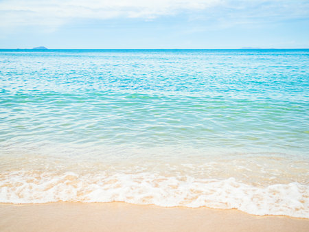 Beach Sand on Sea Background,Shore Summer with White Wave and Blue Ocean,Beautiful Seascape Nature for Tourism Vacation Travle Tropical Holidays,Island at Coast Landscape Paradise Natural Wallpaper.の写真素材