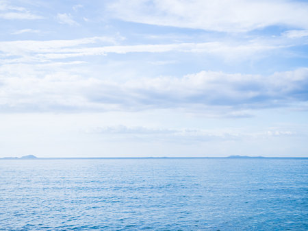 Sea Ocean Horizon Water Background,Calm Blue Shore and Blue Sky White Cloud View Nature Seascape,Texture Wave Clear Backdrop,Summer Tropical Beautiful,Tourism Relax Travel Holidays concept.の写真素材