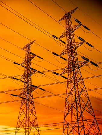 High Voltage Pole on Sunset Background,Power Line Tower electric Transmission Energy Station,Plant Substation Pylon Industry Powerline Grid Generator Tension Station Post.Technology for Environment.の写真素材