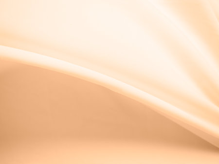 Peach Fabric Soft Silk Background,Blur Abstract Satin Cloth Gold Pastel Surface Glossy Backdrop,Texture Linen Beige Space,Template Wallpaper Product Cosmetic,Smooth Design Tablecloth Material Pattern.の写真素材