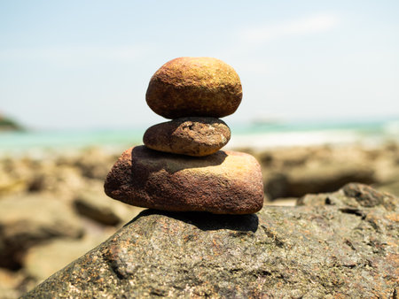 Stack Stone Pebble Zen Balance with blur Water Sea Beach Sand Calm,Concept Spa Stability Spiritual,Pyramid Rock at Coast Island on Nature Harmony Spirit.の写真素材