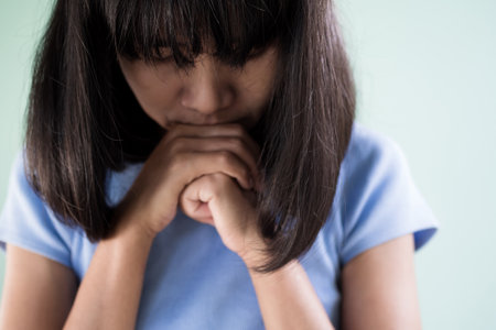 Sad Woman,Face Girl Asian Emotion Anxiety Distress Problem Pain Broken Heart,Unhappy and Stress,Skin tan People Tired Serious Distraught Loneliness Attitude Portrait,Female Alone Couch sick worry.の写真素材