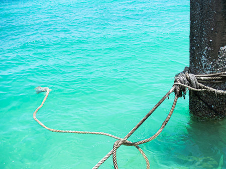 Pole Mooring in Sea Background, Rope Security Safety Boat on Grunge Metal Iron Steel Rust Concrete Corrosion Craft, Coast Blue Ocean Harbour Ship Dock Bollard on Water, Travel Transportation Port.の写真素材