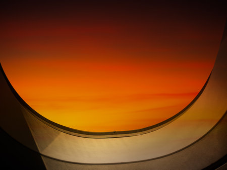 Window Plane Flight Travel View Sunset Orange Color Abstract Sky Horizon Background, Porthole Glass Aeroplane Fly Air Cabin Airline Open Jet, Beauty Dusk Aircraft Aeroplane Inside, Travel Couple Love.の写真素材