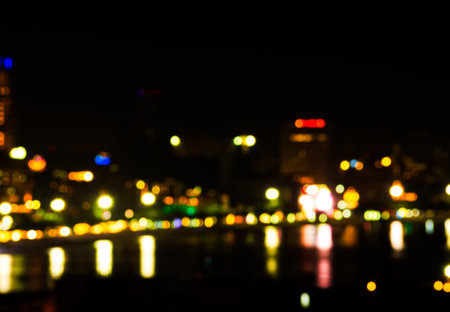 Light Night Bokeh City Blur Focus Background Abstract with Sky Dark Circle Glister blurry Street City Light Urban Cityscape Neon Flare Traffic Evening Car Gold Orange Color Warm Card Happy New Year.の写真素材