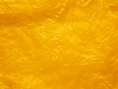 Orange Plastic Texture Wrap Overlay Yellow Background Effect Bag Sticker Foil Pattern Wrinkle Film Grunge Mockup Package Backdrop Scene Color Summer Clear Mockup Poster Glossy Wall Sheet Wrapping.の写真素材
