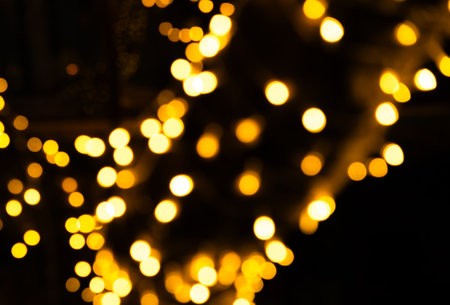 Bokeh Light Night blur Gold Background Abstract Blurry Focus Sky Dark Neon Street Texture Black Backdrop Orange Glitter Confetti Dust Effect Shine City Urban Cityscape.の写真素材