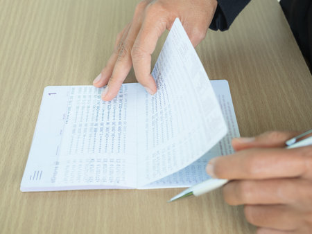 Hand holding Bank Account Book Statement Balance Number Cash, Hand Holding Data Investment Debt Math...