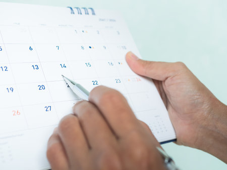 Calendar Schedule Plan Event Organize Timeline Work Office Job and Vacation Travel Holiday, Hand Woman Holding Pen Note Check Date Planner Project Meeting and Saving Money Business Finance Month Week.の写真素材