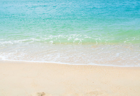 Travel Nature Concept, Sea Sand Background Blue Water at Coast Season Summer Tropical Ocean Beautiful Wave Seascape Vacation Smooth Wallpaper Island Outdoor Tropical Coast Sandy Nature Landscape.の写真素材