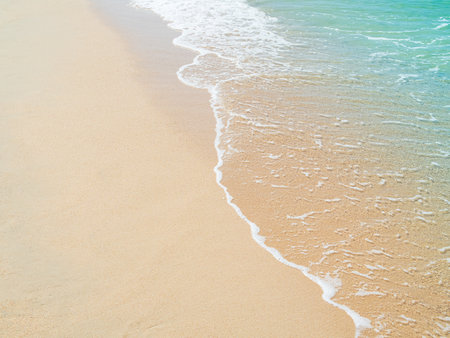 Travel Nature Concept, Sea Sand Background Blue Water at Coast Season Summer Tropical Ocean Beautiful Wave Seascape Vacation Smooth Wallpaper Island Outdoor Tropical Coast Sandy Nature Landscape.の写真素材