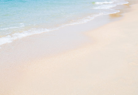 Travel Nature Concept, Sea Sand Background Blue Water at Coast Season Summer Tropical Ocean Beautiful Wave Seascape Vacation Smooth Wallpaper Island Outdoor Tropical Coast Sandy Nature Landscape.の写真素材