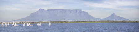 Photo of Table Mountain on a Sunday Afternoon with yachts sailing in the foregroundの写真素材
