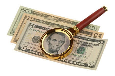 Magnifier and money are isolated on a white backgroundの写真素材
