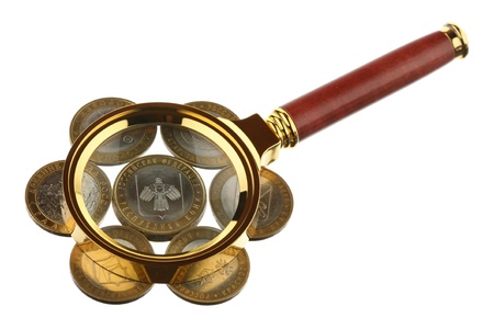 Magnifier and coins are isolated on a white background の写真素材