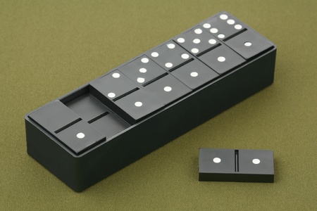 Dominoes - black dice on a green background 