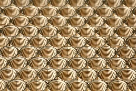 Interesting background of accurately laid brass nuts の写真素材