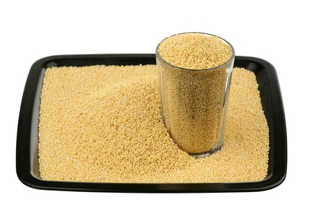Millet, glass and tray on a white background の写真素材