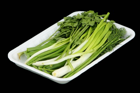 Vegetables in the plastic container on a black background の写真素材