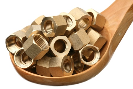 Brass nuts in a wooden spoon on a white background 