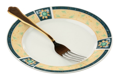 Dinner fork on a plate are isolated on a white background の写真素材