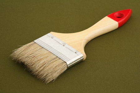 Wide painting brush on a green background 