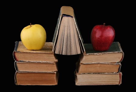 Two apples and seven books on a black background の写真素材