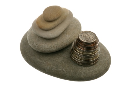Pile of stones and coins over white background 
