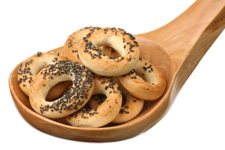 Crisp with a poppy in a wooden spoon on a white background の写真素材