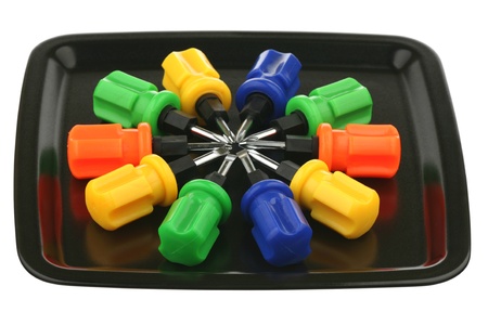 Ten screw-drivers with multi-coloured handles on a tray の写真素材