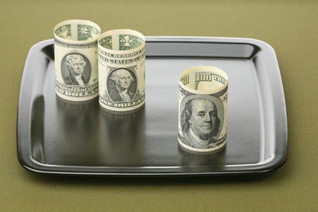 Dollars on a ceramic tray 