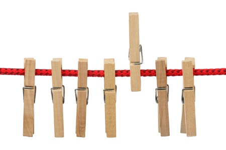 Seven wooden clothespins on the red clothesline 