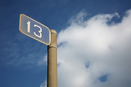 The thirteenth kilometer - a guide sign against the cloudy sky 