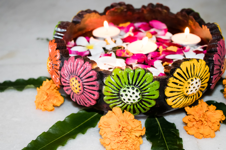 closeup of diwali floting diya with flowers in uruliの写真素材