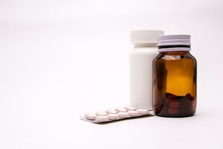White and brown bottle of medicine Bottles, tablets, pills in blister pack, medications drugs selective focus copy spaceの写真素材