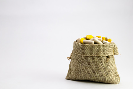 burlap bag full of drug and medicine pills. pharmaceutical cost concept. medications in the cart. buying medicines. . Medicine and pharmacy conceptの写真素材