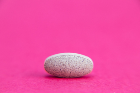 pill isolated on pink background with clipping path. Medicine and pharmacy conceptの写真素材