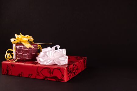 Decorated gift boxes with ribbons and bows on dark contrast background. Gifts conceptの写真素材