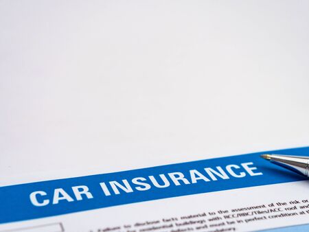 Car insurance paper with a ball pen nib in the sideの写真素材