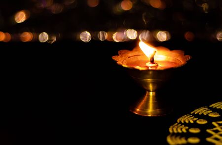 top angle close-up of beautiful diya and yellow rangoli with bokeh background and copy space in the lift. diwali conceptの写真素材