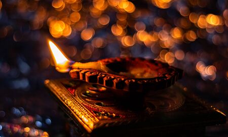 top view close up of beautiful diya on chuwki with bokeh background. lakshmi pooja concept