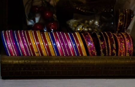 Close up shot of colorful glass and stone bangles in bridal make over conceptの写真素材