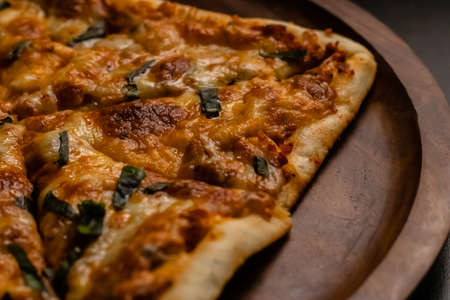 beautiful photography of yummy margarita pizza on wooden plateの写真素材
