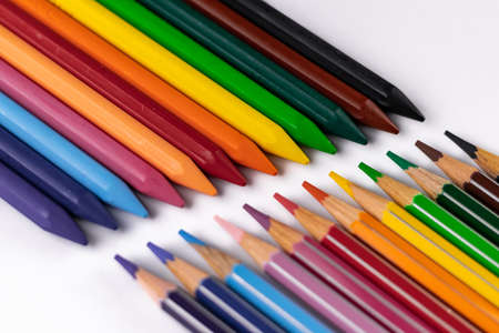 High angle close up shot of crayon and pencil colors shot on white background -Art concept